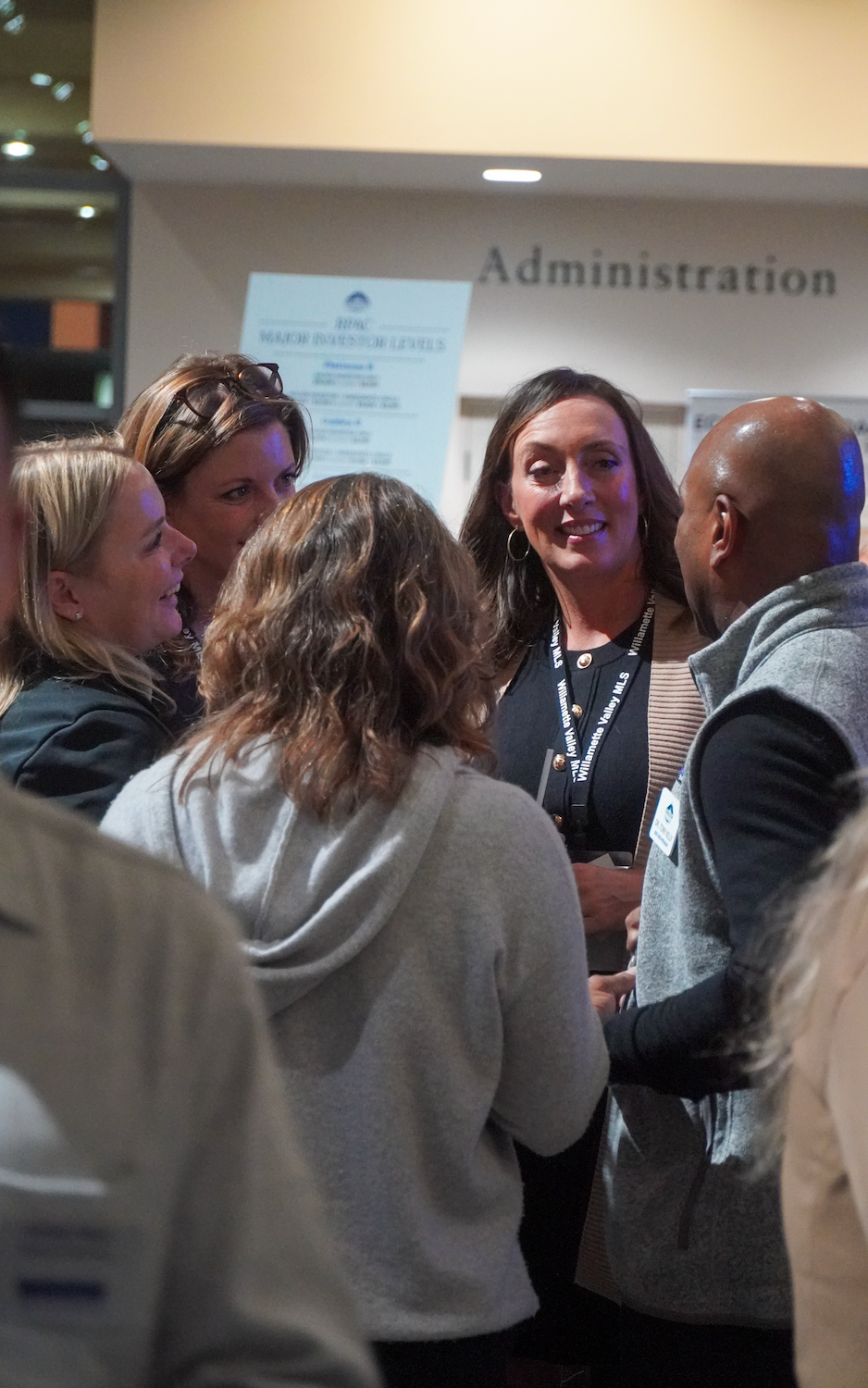 Group of people engaged in conversation at a networking event in an office setting