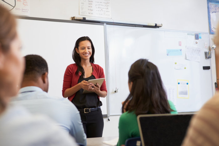 Teacher engaging with adult students in a classroom setting